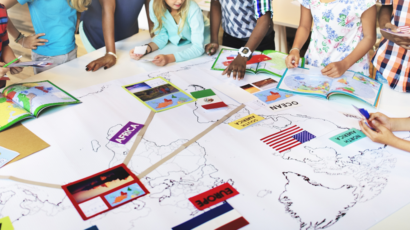 Students working together on Geography projects in the classroom
